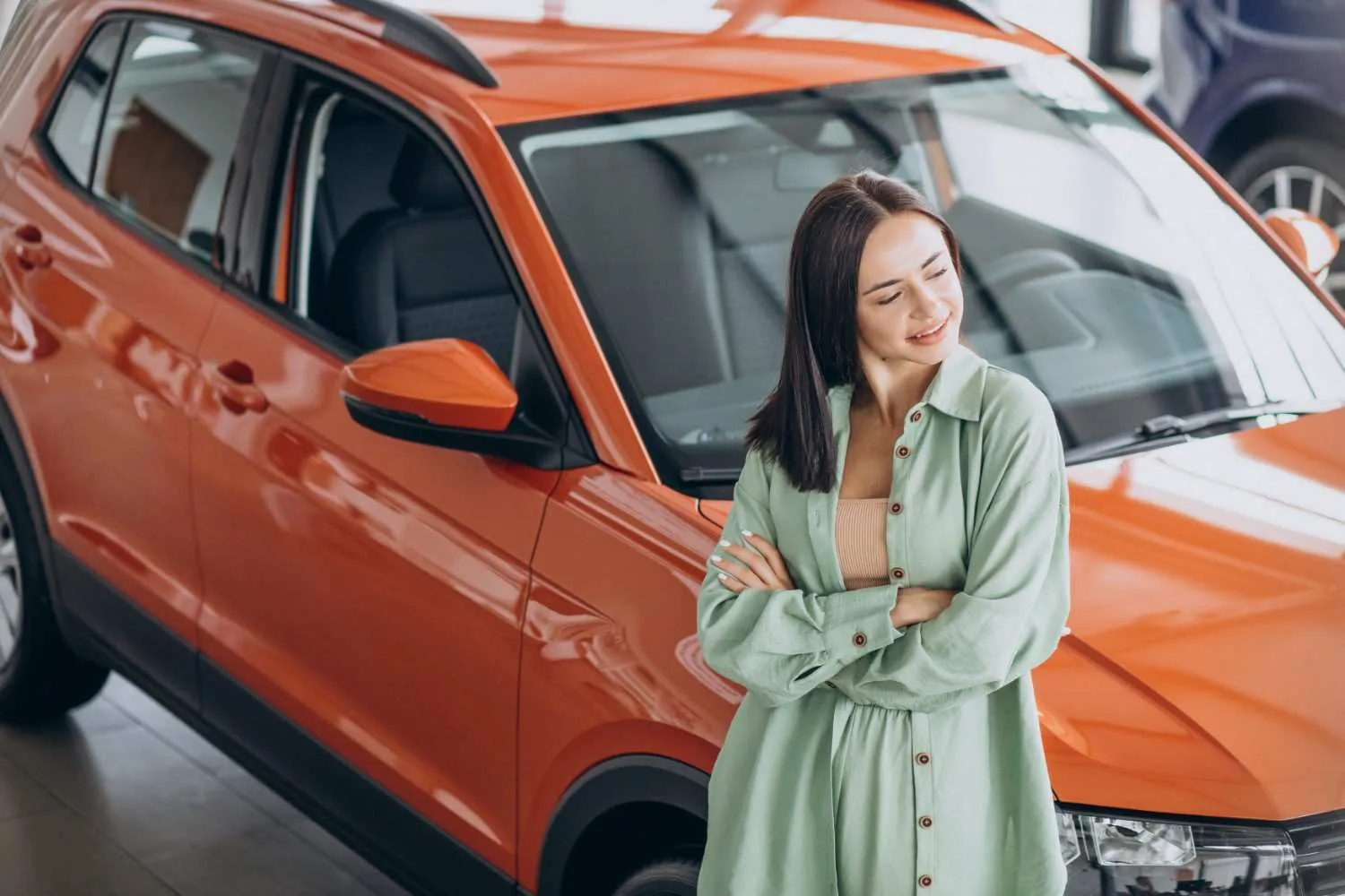 Driver standing beside her car