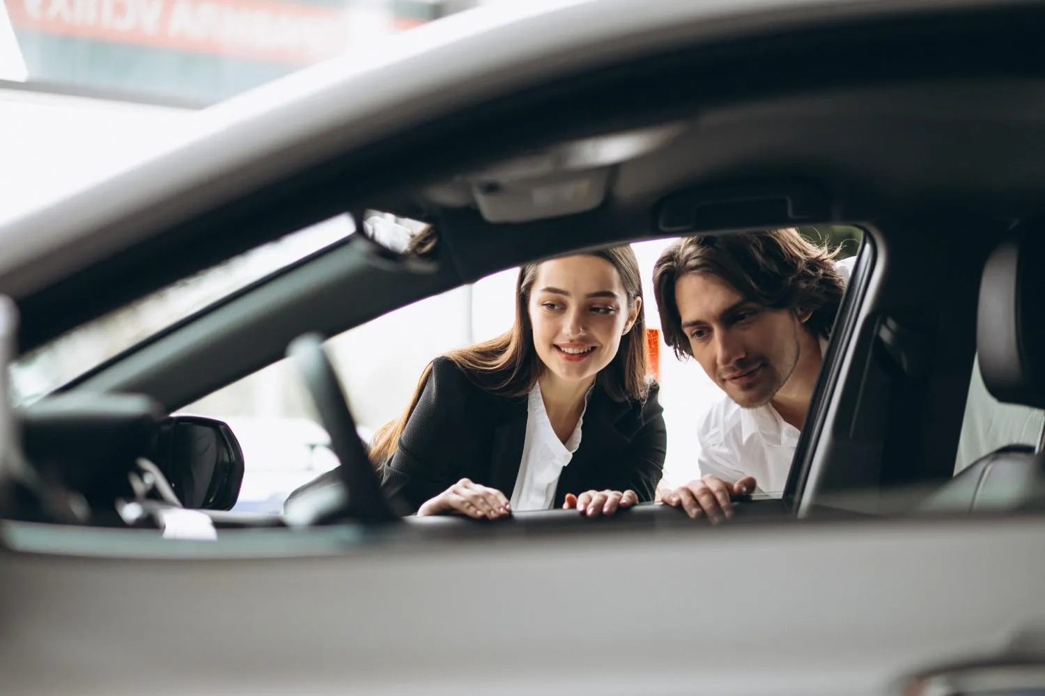 Two drivers looking over a car together